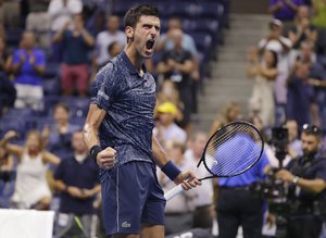 Novak Djokovic, of Serbia, celebrates after defeating John Millman, of Australia, 6-3, 6-4, 6-4 in the quarterfinals of the U.S. Open tennis tournament Wednesday, Sept. 5, 2018, in New York