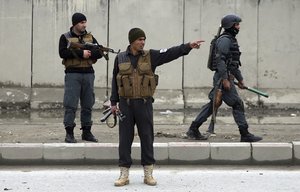 Security forces inspect the site of a suicide attack in Kabul, Afghanistan, Friday, March 2, 2018.