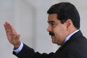 Venezuela's President Nicolas Maduro waves to the press as he arrives for a Mercosur Summit at Itamaraty Palace in Brasilia, Brazil, Friday, July 17, 2015.