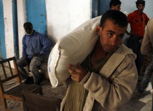 Palestinians receive their monthly food aid at a UN distribution center (UNRWA) at a UN distribution center in the Rafah refugee camp, southern Gaza Strip on November 15, 2012. Saeb Erekat said the United States suspended its financial aid to the Palestinian Authority, and confirmed the existence of differences between the Palestinian Authority and the U.S. Administration about the trend to seek membership in the "UN".Photo by Ahmed Deeb / WN