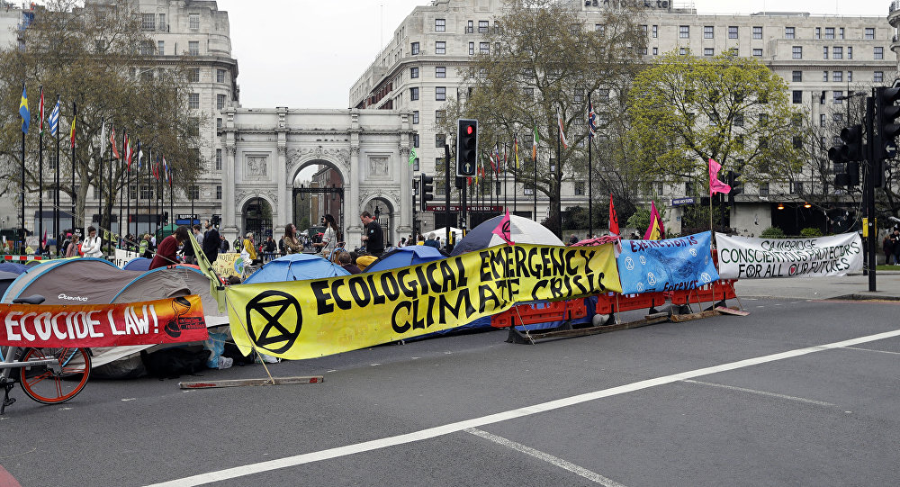 The road is blocked by demonstrators during a climate protest at Marble Arch in London, Tuesday, April 16, 2019