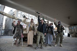 Houthi Shiite fighters chant slogans as they guard a street leading to the residence of Yemen's former President Ali Abdullah Saleh in Sanaa, Dec. 04, 2017.