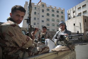 File - Shiite fighters, known as Houthis, pose for a photo as they secure a road, as people take part in a march, denouncing plans by the Arab coalition to attack Hodeidah, from Sanaa to the port city of Hodeidah, Yemen, Wednesday, Apr. 19, 2017.