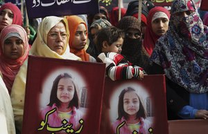 Women supporters of Pakistan Awami Tehreek hold the posters of Zainab Ansari, an 8-year-old girl who was raped and kidnapped in Kasur, during a demonstration to condemn the rape and killing of young girl, in Lahore, Pakistan, Saturday, Jan. 13, 2018.