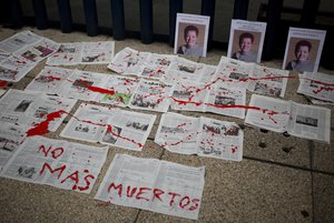 A message that reads in Spanish: “No More Deaths” is written in red paint on newspapers placed in front of photos of Mexican journalist Miroslava Breach, who was gunned down in the northern state of Chihuahua on Thursday,