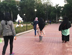 Muslim women wearing headscarves or hijab have a stroll at a park. Taken on April 2017.