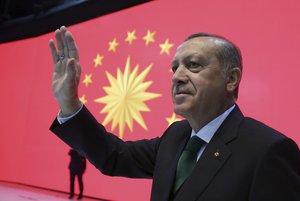 Turkey's President Recep Tayyip Erdogan waves to his supporters during a meeting in Istanbul, Monday, March 27, 2017. T