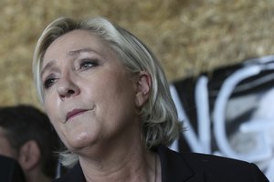 French far-right leader and candidate for the presidential election Marine Le Pen looks on as she visits a pork-farm in Pordic, westernFrance, Thursday March 30, 2017. The two-round presidential election is set for April 23 and May 7.