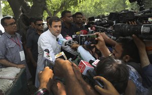 Congress party president Rahul Gandhi, center, talks to media outside his home after casting his vote during the sixth phase of general elections in New Delhi, India, Sunday, May 12, 2019.