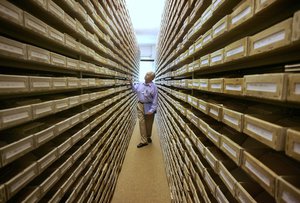 -FILE- In this May 8, 2008 file picture Gary Mokotoff, a Jewish genealogist from New Jersey, takes a look at name registers at the International Tracing Service in Bad Arolsen, central Germany.