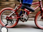 A red bicycle with trainer wheels