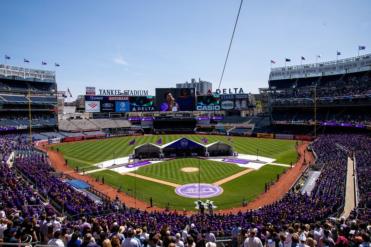 graduates celebrating at Yankee Stadium