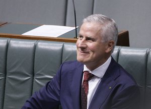 Australian Nationals party leader and Deputy Prime Minister, Michael McCormack, smiles while sitting in parliament in Canberra, Monday, Feb. 26, 2018.