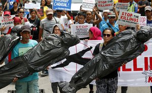 Protesters carry effigies symbolizing thousands of victims killed in the so-called war on drugs of Philippine President Rodrigo Duterte as they march for a rally outside the Philippine National Police in Quezon city, northeast of Manila, Philippines, Thursday, July 20, 2017.