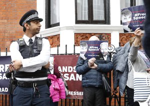 British police arrive and guard the Ecuadorian Embassy as protesters in support of Wikileaks founder Julian Assange demonstrate outside the embassy in London, Monday, May 20, 2019.