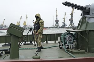 A Ukrainian serviceman stands on board a coast guard ship in the Sea of Azov port of Mariupol, eastern Ukraine, Monday, Dec. 3, 2018.