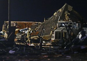 Emergency workers search through debris from a mobile home park, Sunday, May 26, 2019, in El Reno, Ok., following a likely tornado touchdown late Saturday night