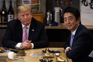 President Donald Trump sits at dinner with Japanese Prime Minister Shinzo Abe, Sunday, May 26, 2019, in Tokyo