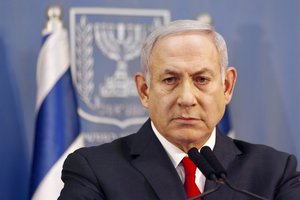 Israeli Prime Minister Benjamin Netanyahu delivers a statement in Tel Aviv, Israel, Sunday, Nov. 18, 2018. Netanyahu says he will take over temporarily as defense minister as early elections still loom.