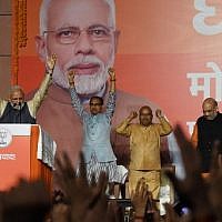 India Prime Minister Narendra Modi (L) gestures on stage during his victory speech at the Bharatiya Janta Party (BJP) headquaters after winning India's general election, in New Delhi on May 23, 2019. (Photo by PRAKASH SINGH / AFP)