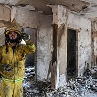 Firefighters survey damage from a fire in Kibbutz Harel, on May 24, 2019. (Noam Revkin Fenton/Flash90)