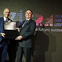 Brazilian President Jair Bolsonaro (R) receives a plaque marking Israel's 71st birthday at an event in the Israeli Embassy in Brasilia on May 22, 2019 (Courtesy of Israeli embassy in Brasilia)