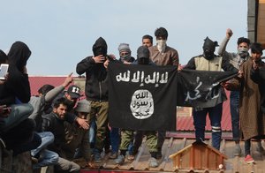 Protestors hold ISIS flags during his funeral procession  of slain militant Eesa Fazili  in Srinagar, the summer capital of Indian Kashmir, 12 March 2018. Fazili one of the three militants, killed in a brief gunfight with governments forces in village Malikpora, Hakura area of south Kashmir's Anantnag district.