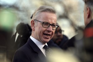 Britain's environment secretary Michael Gove speaks to the media outside the Houses of Parliament, in London, Wednesday December 12, 2018.