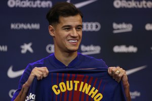 Barcelona's new signing Brazilian Philippe Coutinho poses for the media, during his official presentation at the Camp Nou stadium in Barcelona, Spain