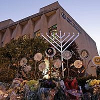 A menorah and flowers are seen outside the Tree of Life Synagogue in preparation for a celebration service on the first night of Hanukkah, in the Squirrel Hill neighborhood of Pittsburgh, December 2, 2018. (AP Photo/Gene J. Puskar)