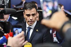 Spain's Prime Minister Pedro Sanchez talks with journalists as he leaves an EU summit in Brussels, early Friday, June 29, 2018.