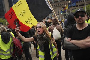 A yellow vest protestor chants slogans during a demonstration in Brussels, Sunday, May 26, 2019.