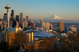 The Seattle city skyline at sunset with the Space Needle, downtown and Mount Rainier from Queen Anne Hill.