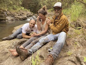 In this Friday, May 24, 2019, photo provided by Troy Jeffrey Helmer, shows Amanda Eller, second from left, after being found by searchers, Javier Cantellops, far left, and Chris Berquist, right, above the Kailua reservoir in East Maui, Hawaii, on Friday afternoon.