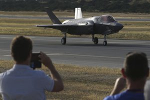 People take photos as the F-35B aircraft lands at Akrotiri Royal air forces base near city of Limassol, Cyprus, Tuesday, May 21, 2019