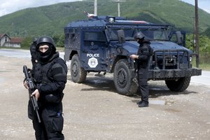 Kosovo police special unit members secure the area near the village of Cabra, north western Kosovo, during an ongoing police operation on Tuesday, May 28, 2019.