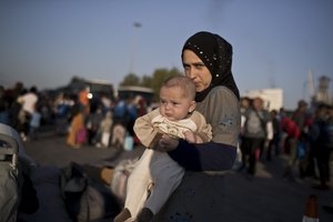 File - 19 year old Nermi Zeitoun from Idlib , Syria, holds her three month old baby Mohhamed Lousman after they disembark from a ferry, at the port of Piraeus, near Athens, Tuesday, Sept. 25, 2018.