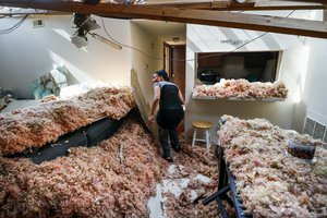 Erica Bohannon, leads reporters through her destroyed apartment after a tornado storm system passed through the area the night before, tearing her roof off while she huddled with her son and dog in her bedroom closet, Tuesday, May 28, 2019, in Trotwood, Ohio.