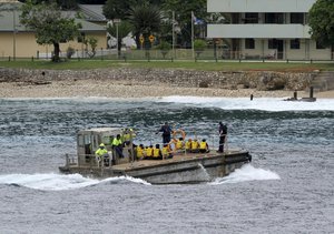 In this photo taken on April 14, 2013, a group of Vietnamese asylum seekers are taken by barge to a jetty on Australia's Christmas Island. An unexpected spike in the numbers of Vietnamese people reaching Australia and asking for asylum is drawing fresh scrutiny toward Hanoi's deteriorating human rights record and risks complicating relations with Australia. (AP Photo)