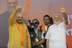 Indian Prime Minister Narendra Modi and Bharatiya Janata Party (BJP) President Amit Shah greets people during a public meeting in Ahmadabad, India, Sunday, May 26, 2019.