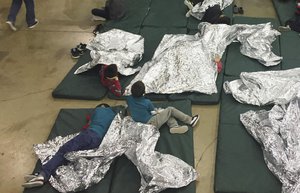 In this photo provided by U.S. Customs and Border Protection, people who've been taken into custody related to cases of illegal entry into the United States, rest in one of the cages at a facility in McAllen, Texas, Sunday, June 17, 2018.