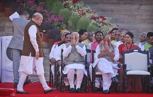 Indian Prime Minister Narendra Modi, center, and Rajnath Singh greet Bharatiya Janata Party president Amit Shah, left, as he returns after being sworn in as a cabinet minister in New Delhi, India, Thursday, May 30, 2019.