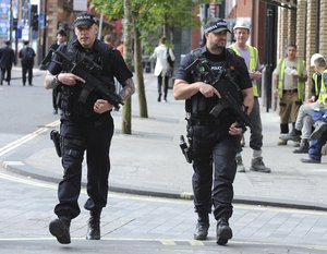 Armed police patron the streets near to the Manchester Arena in central Manchester, England Tuesday May 23 2017.