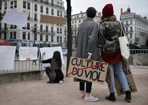 In this Oct. 29, 2017 file photo, a woman holds a banner that reads: 'Rape Culture' during a demonstration in Lyon, central France, to support the wave of testimonies denouncing cases of sexual harassment.