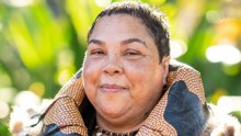 Theresa Ardler proudly wears the budbili, or possum-skin cloak that she made herself.