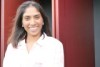 Nutritionist Anneline Padayachee stands in front of red dairy