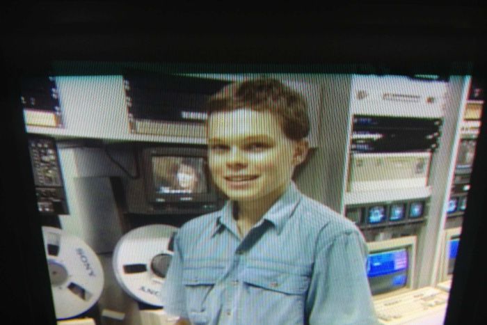 Paul Lyons stands in front of television broadcast equipment in 1992.