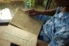 A man an old, yellow book detailing family history.