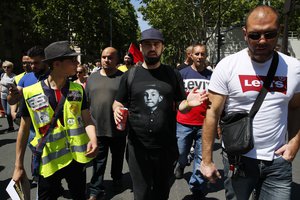 Eric Drouet, a prominent and divisive figure of the yellow vest movement, center, takes part to a march, in Paris, Saturday, June 1, 2019