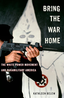 Cover of Bring the War Home, showing man pointing automatic weapon with KKK robe in background